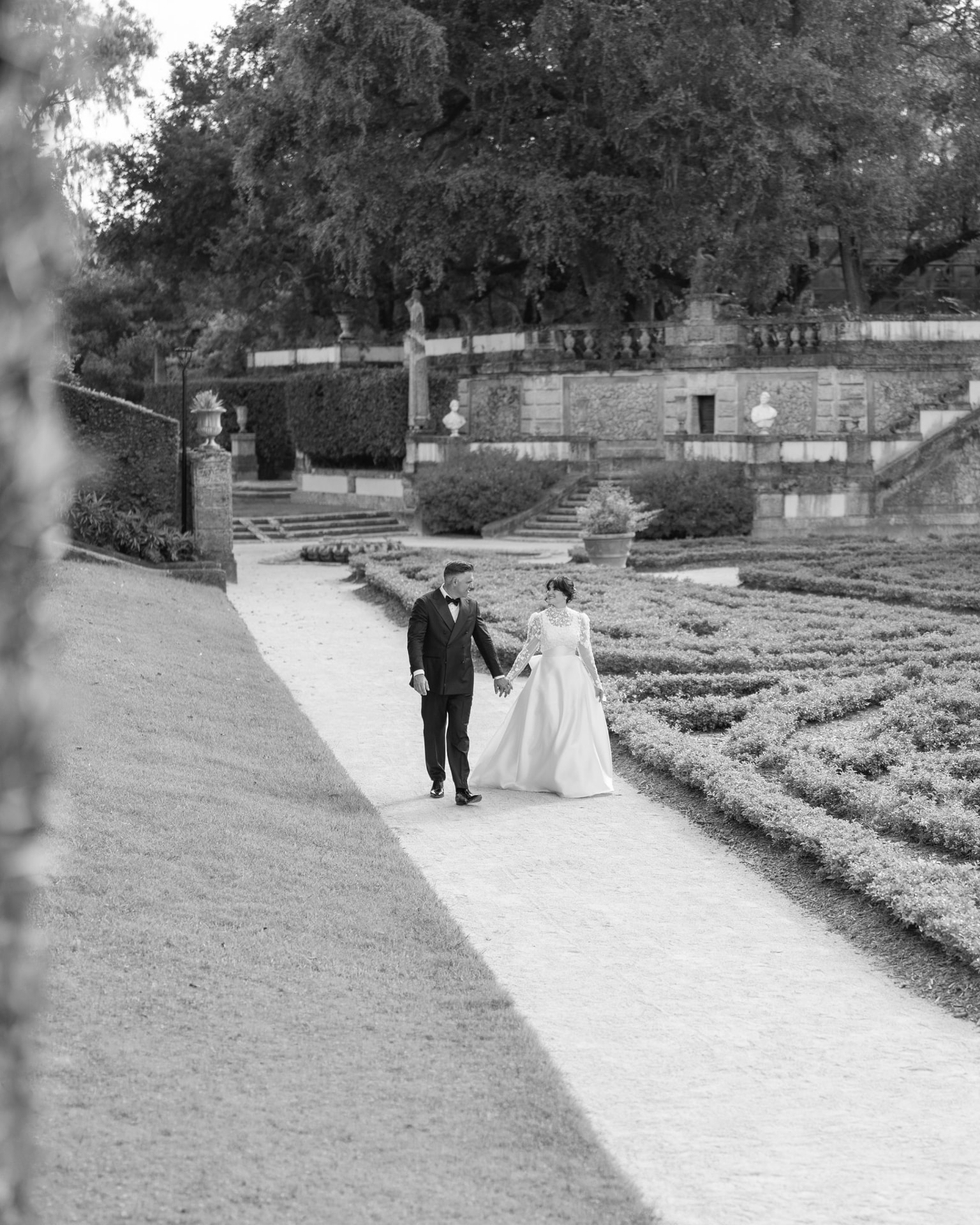 Couple walking hand in hand through the gardens of Vizcaya